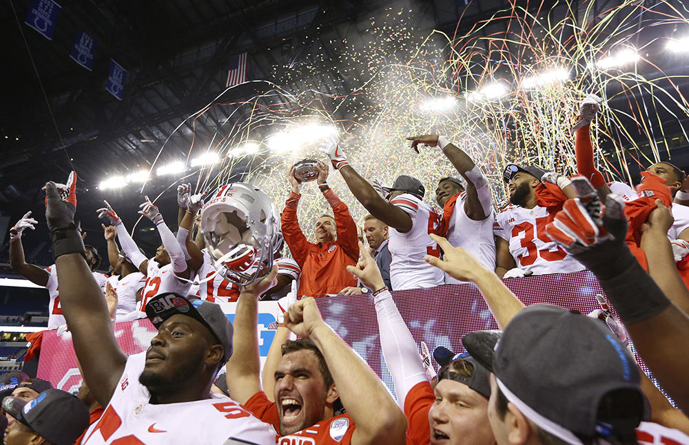 SSports Feature - 1st place   - Ohio State head coach Urban Meyer hoists the championship trophy following the Buckeyes' 27-21 win over the Wisconsin Badgers in the Big Ten championship game at Lucas Oil Stadium in Indianapolis. (Adam Cairns / The Columbus Dispatch)